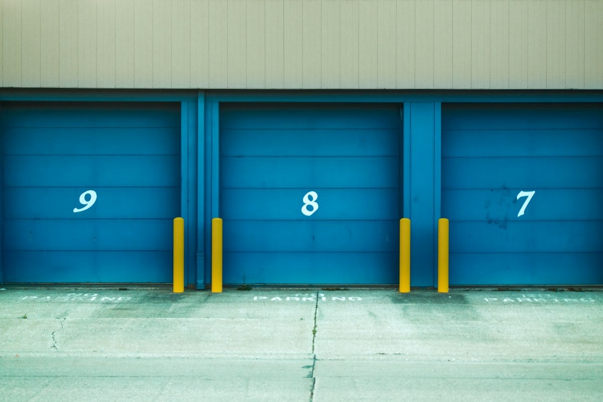 Numbered blue roller doors on a warehouse bay