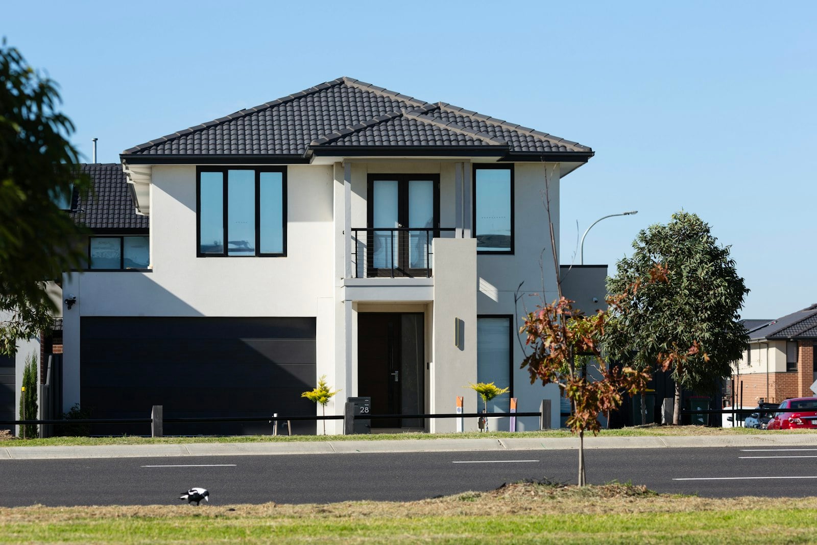 Two-story house with a dark garage door facing the street